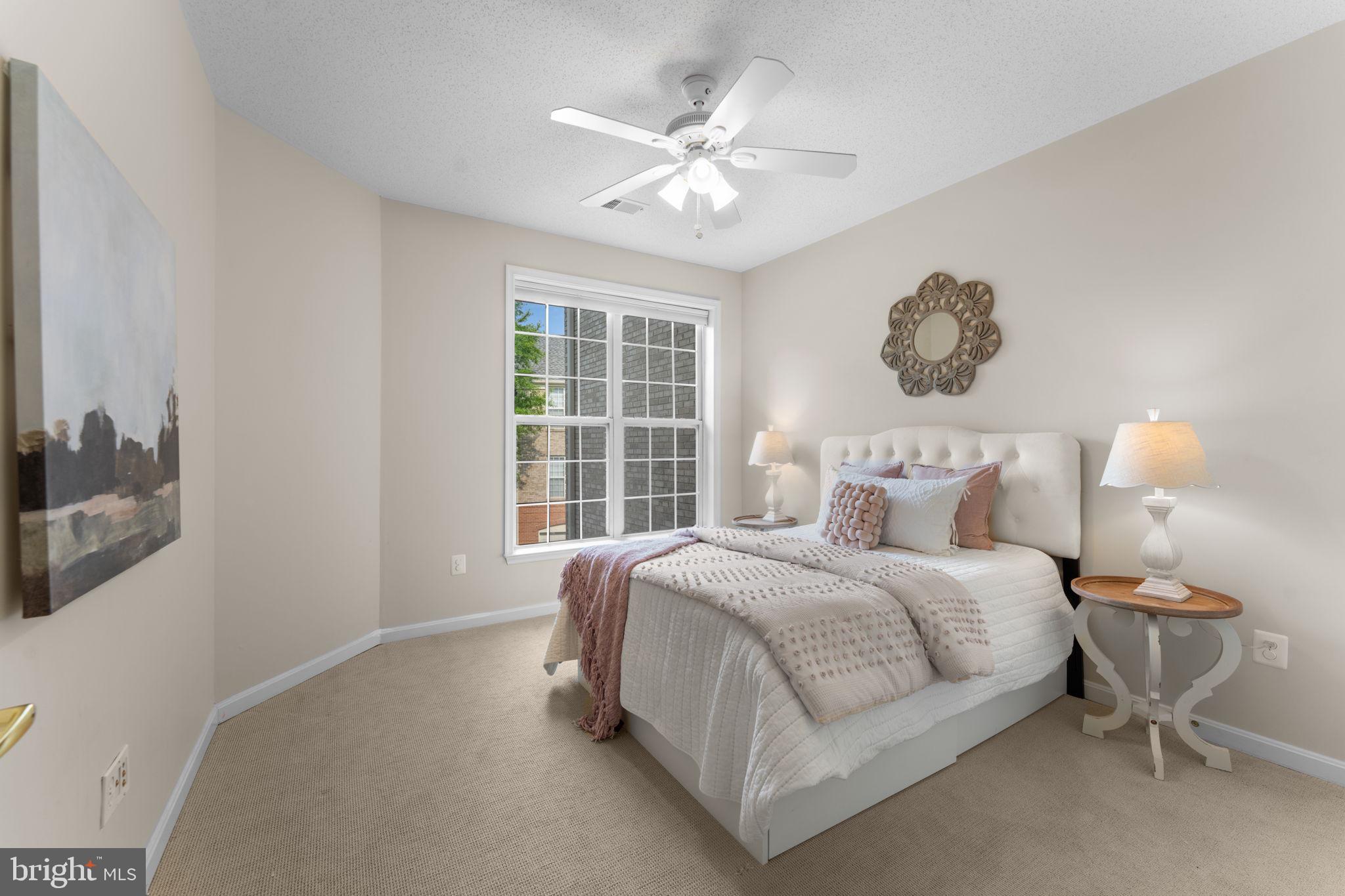 12170 Abington Hall Place, Unit 201 Reston, VA 20190 - Photo 20 of 39 a bedroom with a large bed and a chandelier