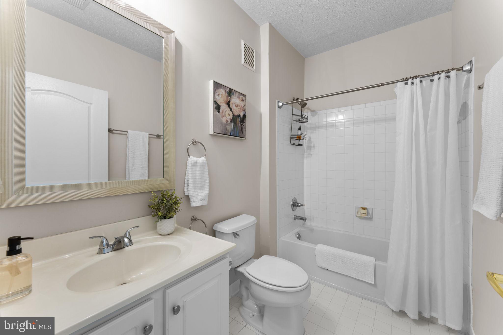 12170 Abington Hall Place, Unit 201 Reston, VA 20190 - Photo 21 of 39 a bathroom with a sink toilet and shower