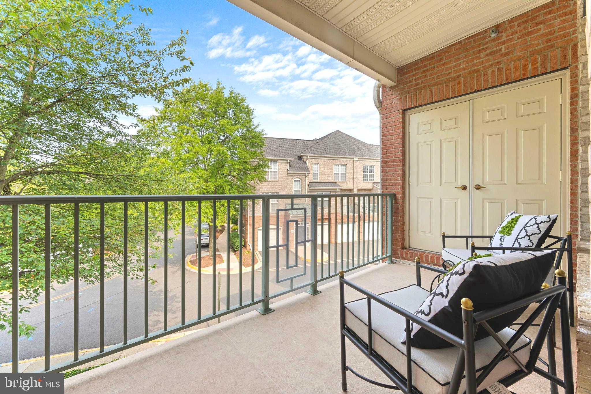 12170 Abington Hall Place, Unit 201 Reston, VA 20190 - Photo 24 of 39 a view of a balcony with chairs