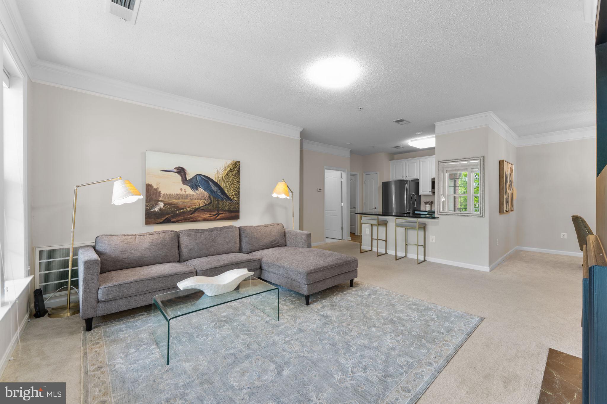 12170 Abington Hall Place, Unit 201 Reston, VA 20190 - Photo 5 of 39 a living room with furniture and kitchen view