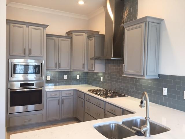 106 York Ln Inlet Beach, Unit C265 Inlet Beach, FL 32461 - Photo 3 of 19 a kitchen with stainless steel appliances granite countertop a sink stove and cabinets