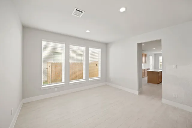 an empty room with windows and entrance