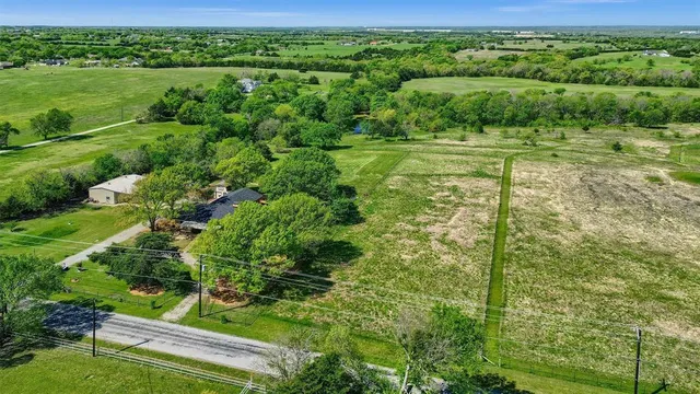 a view of a lush green outdoor space with a lake view