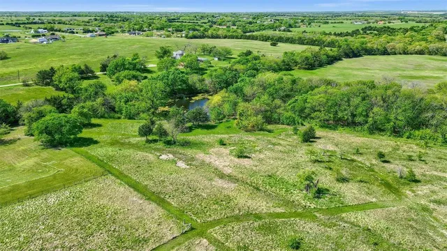 a view of a lush green outdoor space with a lake view