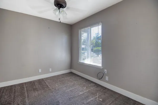 a room with a window and a ceiling fan