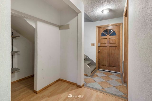 a view of entryway and hall with wooden floor