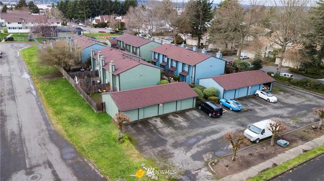 a bathroom with a toilet a sink a mirror and vanity