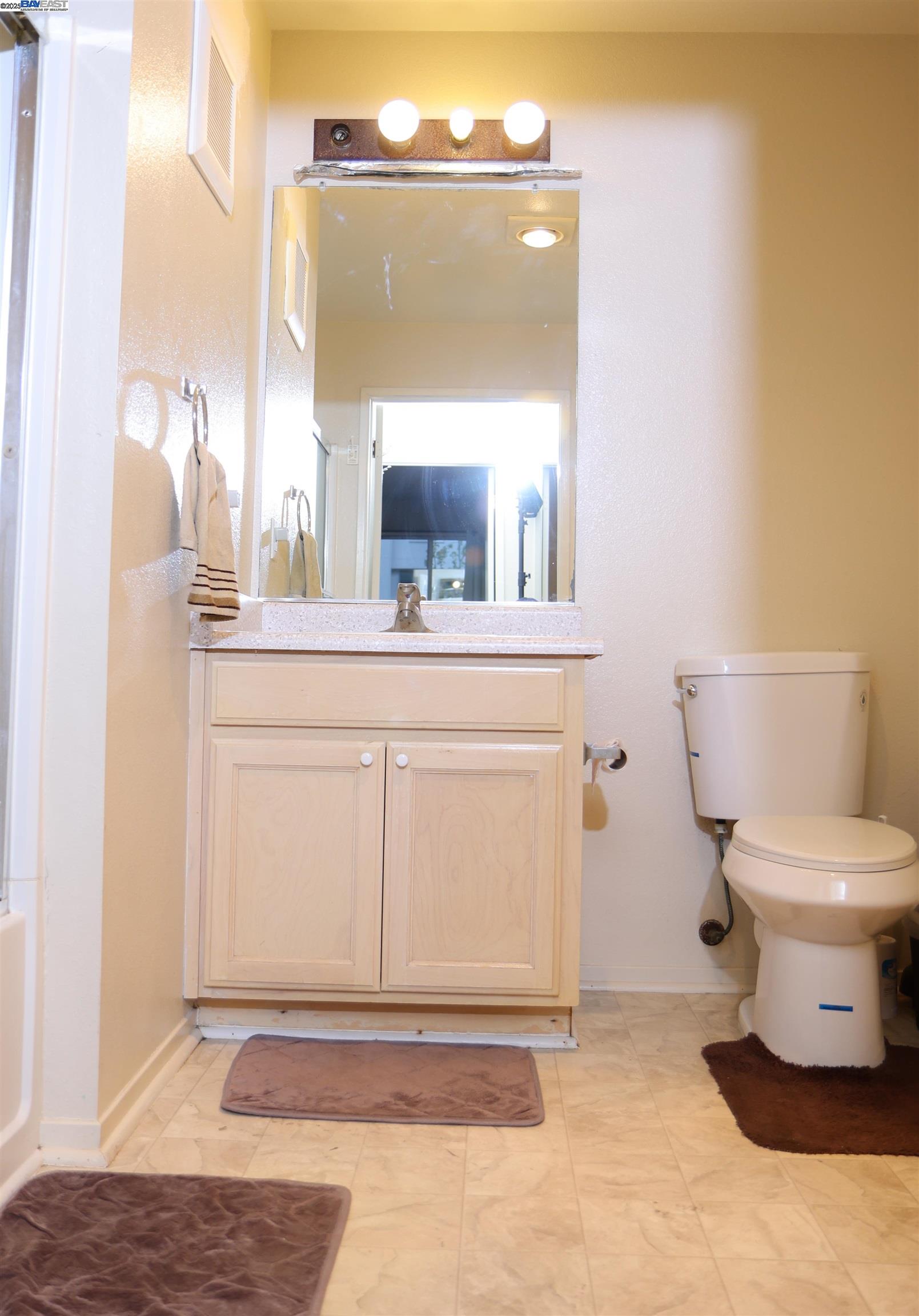 839 Printempo Place San Jose, CA 95134 - Photo 28 of 54 a bathroom with a toilet a sink and a mirror