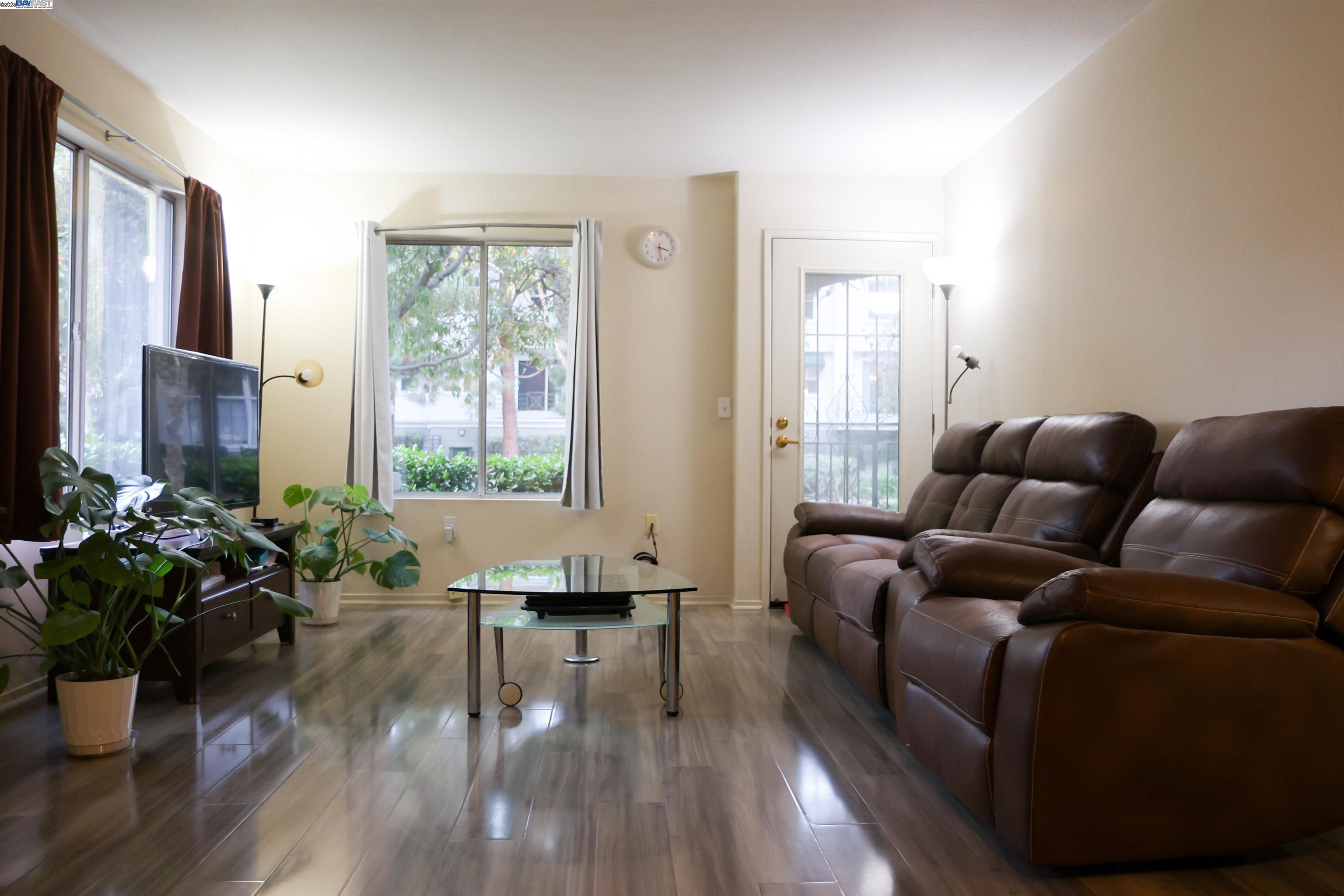 839 Printempo Place San Jose, CA 95134 - Photo 8 of 54 a living room with furniture potted plant floor to ceiling window and wooden floor