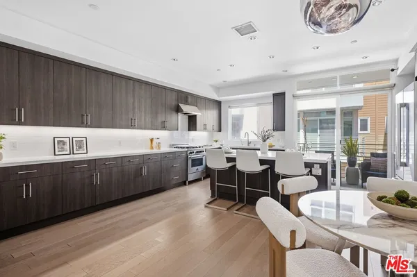a kitchen with a sink stove and white cabinets