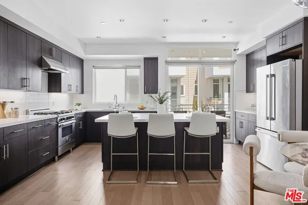 a kitchen with a stove sink and a refrigerator