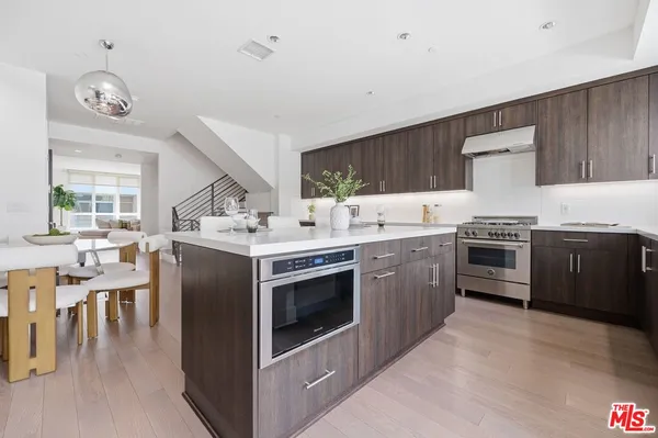 a bedroom with a bed and painting on the wall