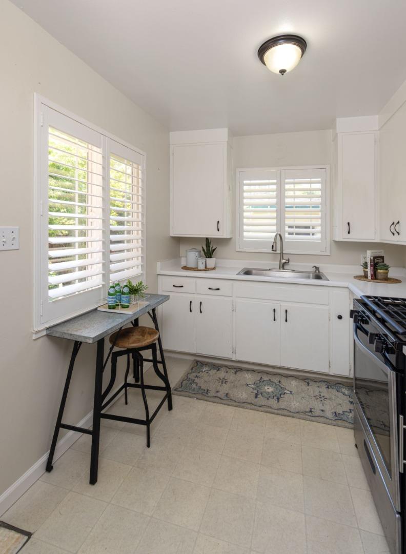 710-712 Riverview Drive Capitola, CA 95010 - Photo 25 of 37 a kitchen with a sink window and cabinets