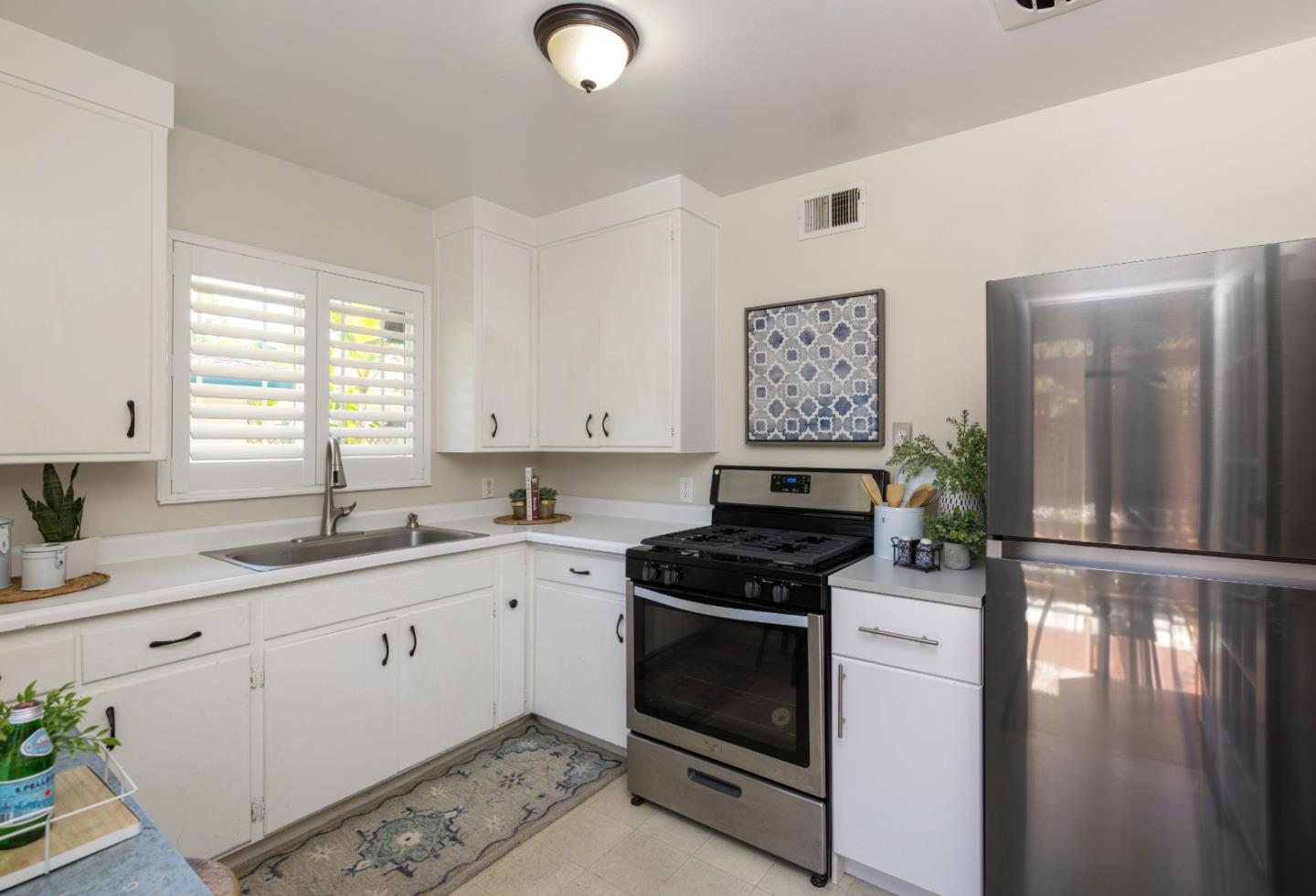 710-712 Riverview Drive Capitola, CA 95010 - Photo 26 of 37 a kitchen with granite countertop a sink a stove and cabinets