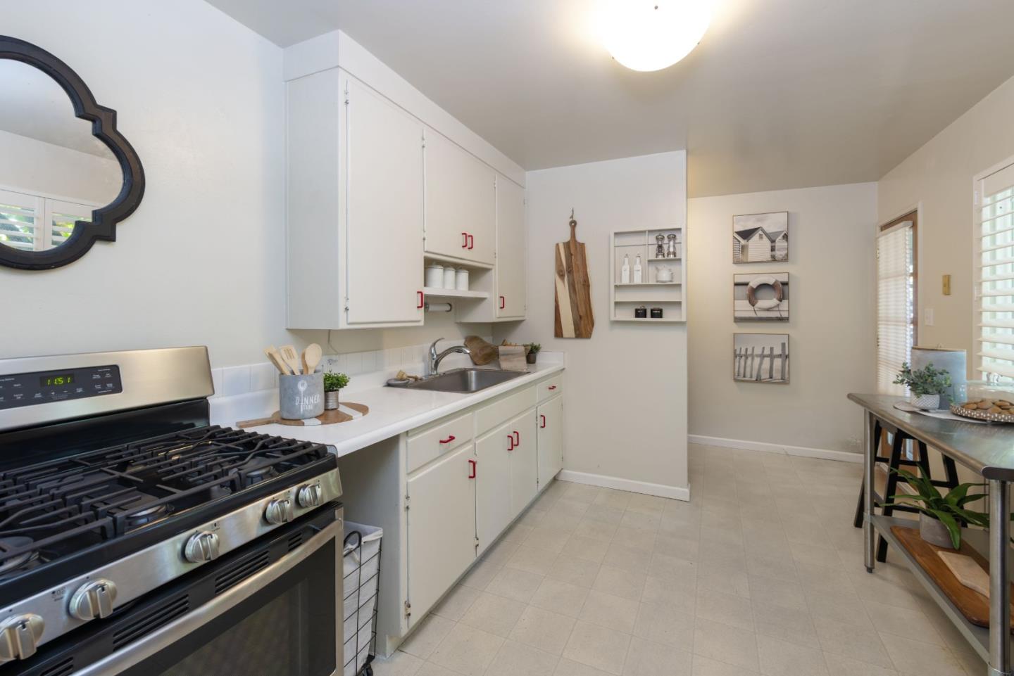 710-712 Riverview Drive Capitola, CA 95010 - Photo 7 of 37 a kitchen with stainless steel appliances a stove a sink and a refrigerator