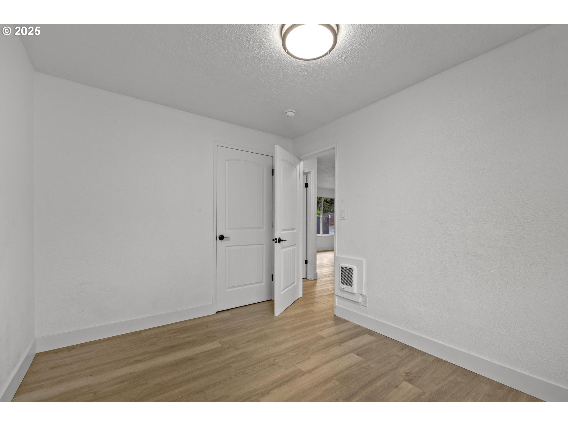 4804-4806 Northeast 111th Avenue Portland, OR 97220 - Photo 13 of 44 a view of empty room with wooden floor