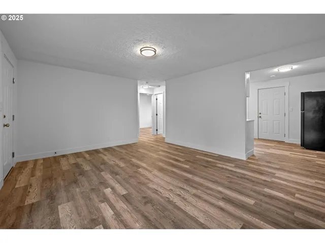 a view of an empty room and wooden floor