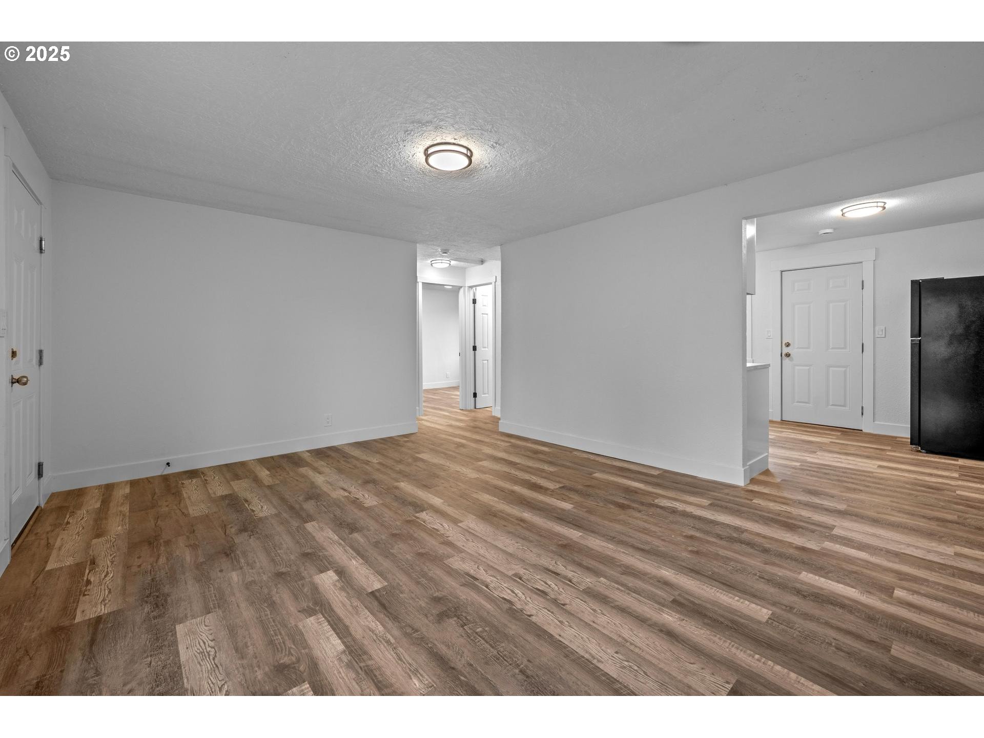 4804-4806 Northeast 111th Avenue Portland, OR 97220 - Photo 22 of 44 a view of an empty room and wooden floor