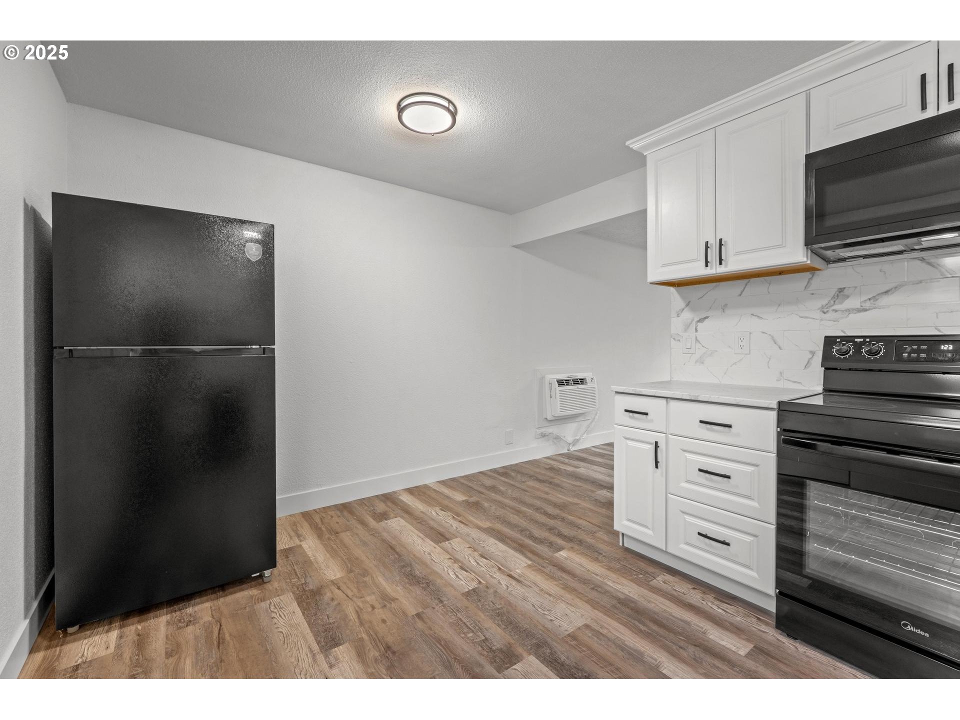 4804-4806 Northeast 111th Avenue Portland, OR 97220 - Photo 25 of 44 a kitchen with a refrigerator and a stove top oven