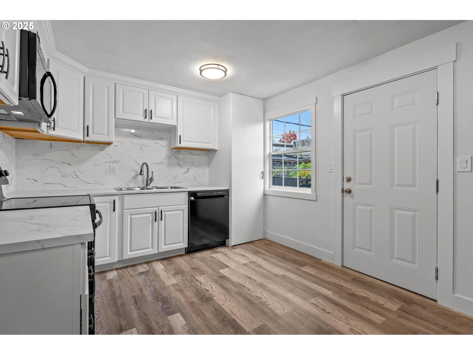 4804-4806 Northeast 111th Avenue Portland, OR 97220 - Photo 26 of 44 a kitchen with a sink cabinets and window