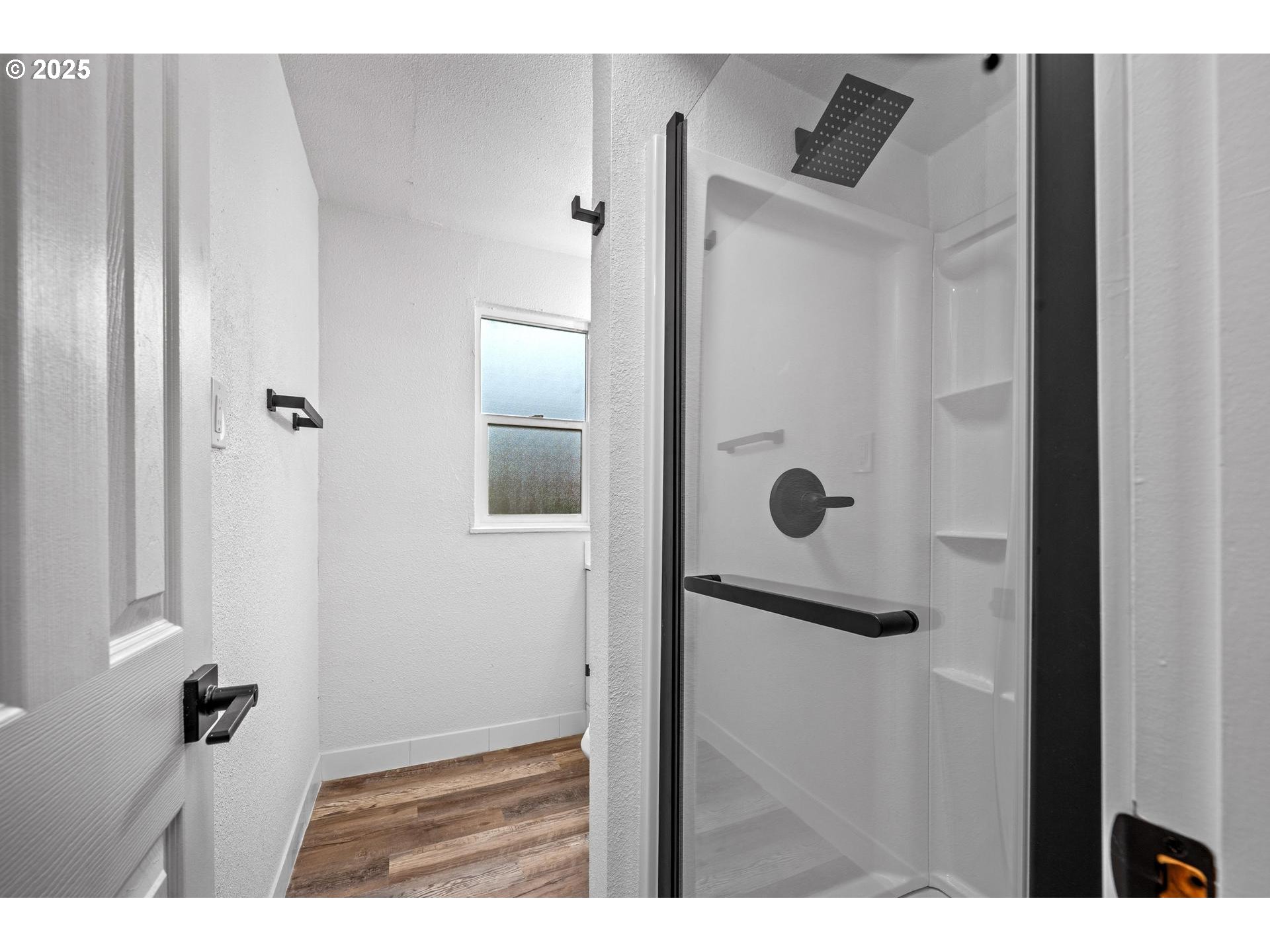 4804-4806 Northeast 111th Avenue Portland, OR 97220 - Photo 32 of 44 a bathroom with a glass shower door