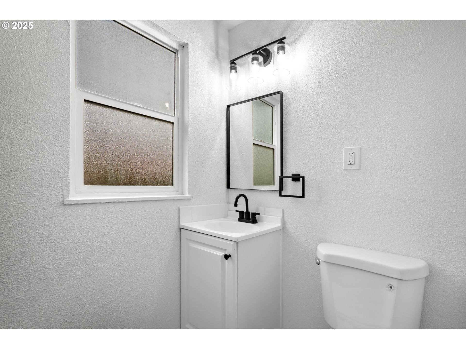 4804-4806 Northeast 111th Avenue Portland, OR 97220 - Photo 33 of 44 a bathroom with a sink and a mirror