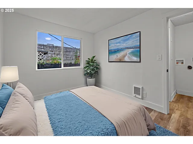 a bedroom with a bed and a painting on the wall