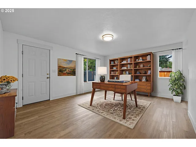 a workspace room with furniture and wooden floor
