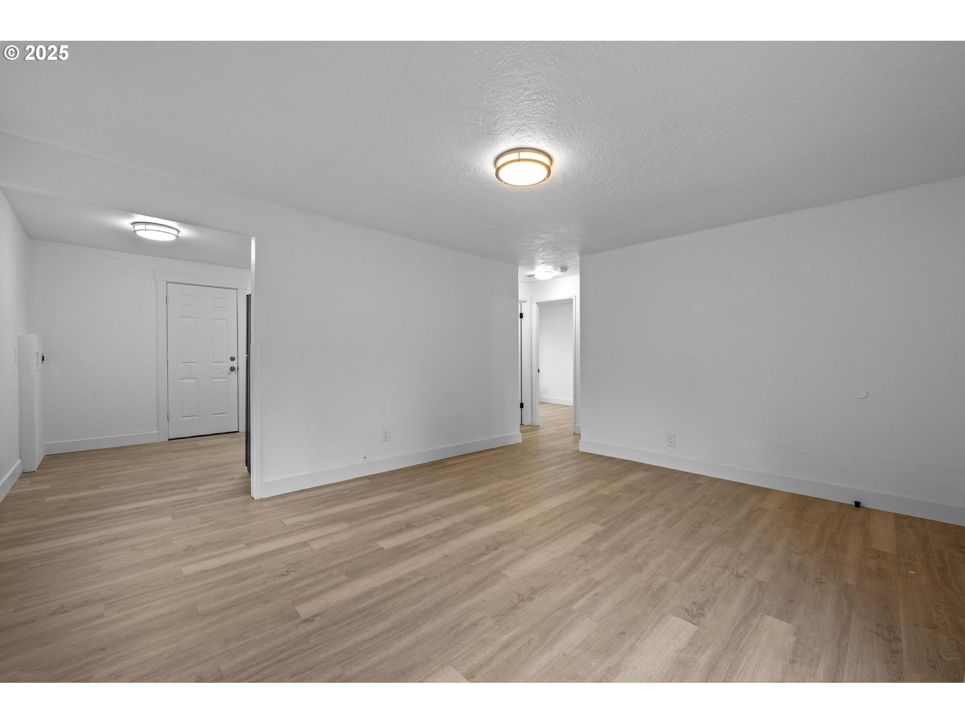 4804-4806 Northeast 111th Avenue Portland, OR 97220 - Photo 6 of 44 a view of an empty room with wooden floor