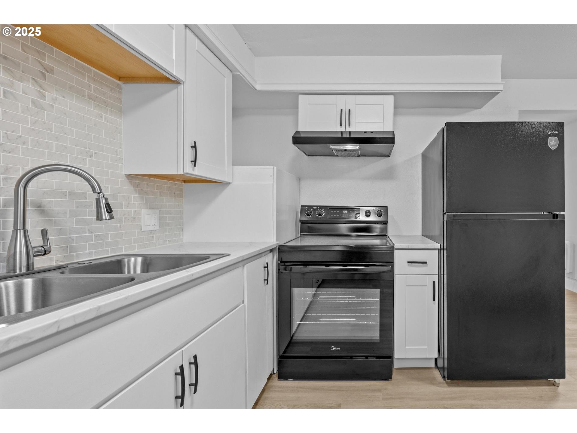 4804-4806 Northeast 111th Avenue Portland, OR 97220 - Photo 9 of 44 a kitchen with a refrigerator sink and cabinets