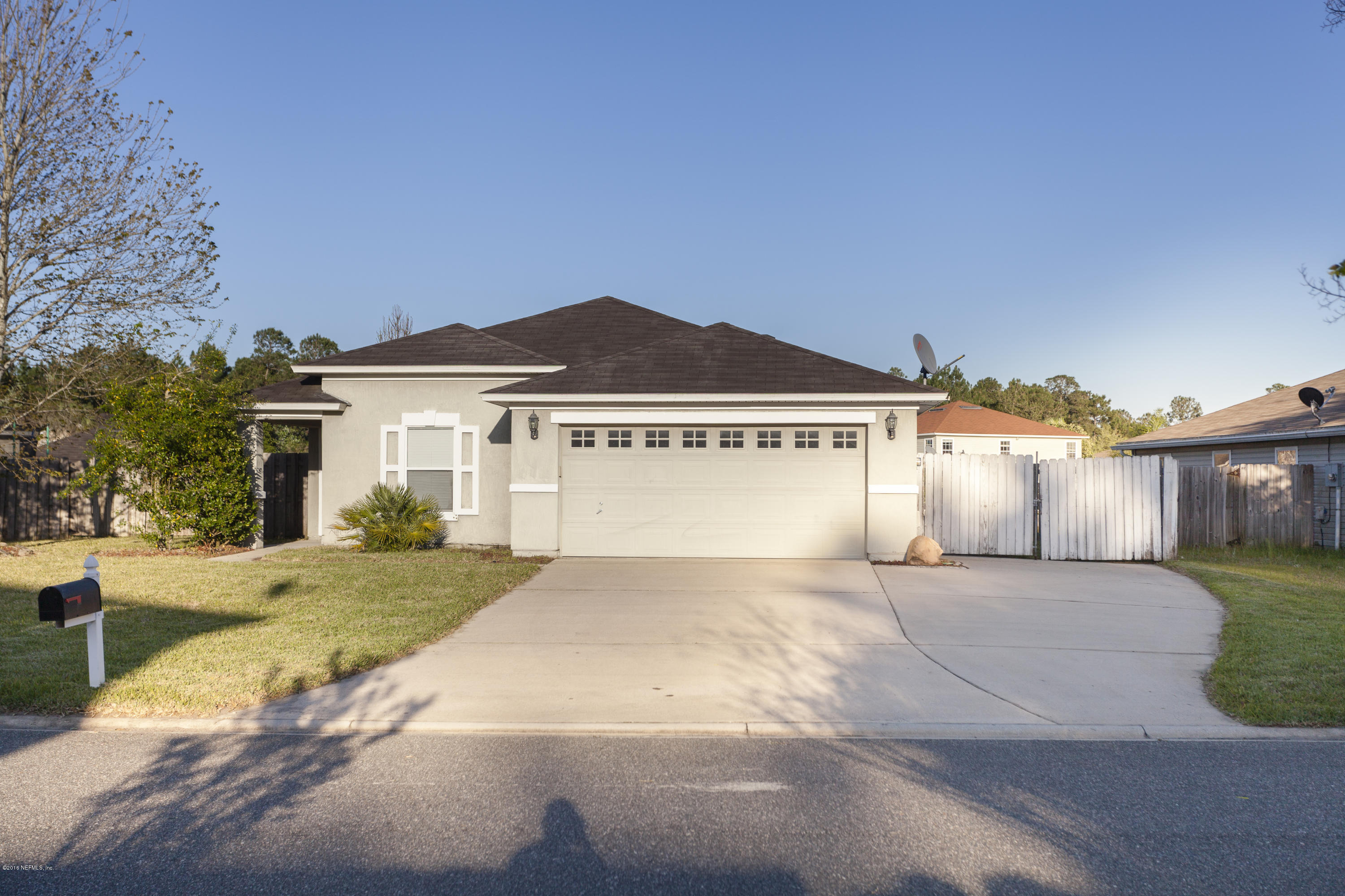 a view of a house with a yard and garage