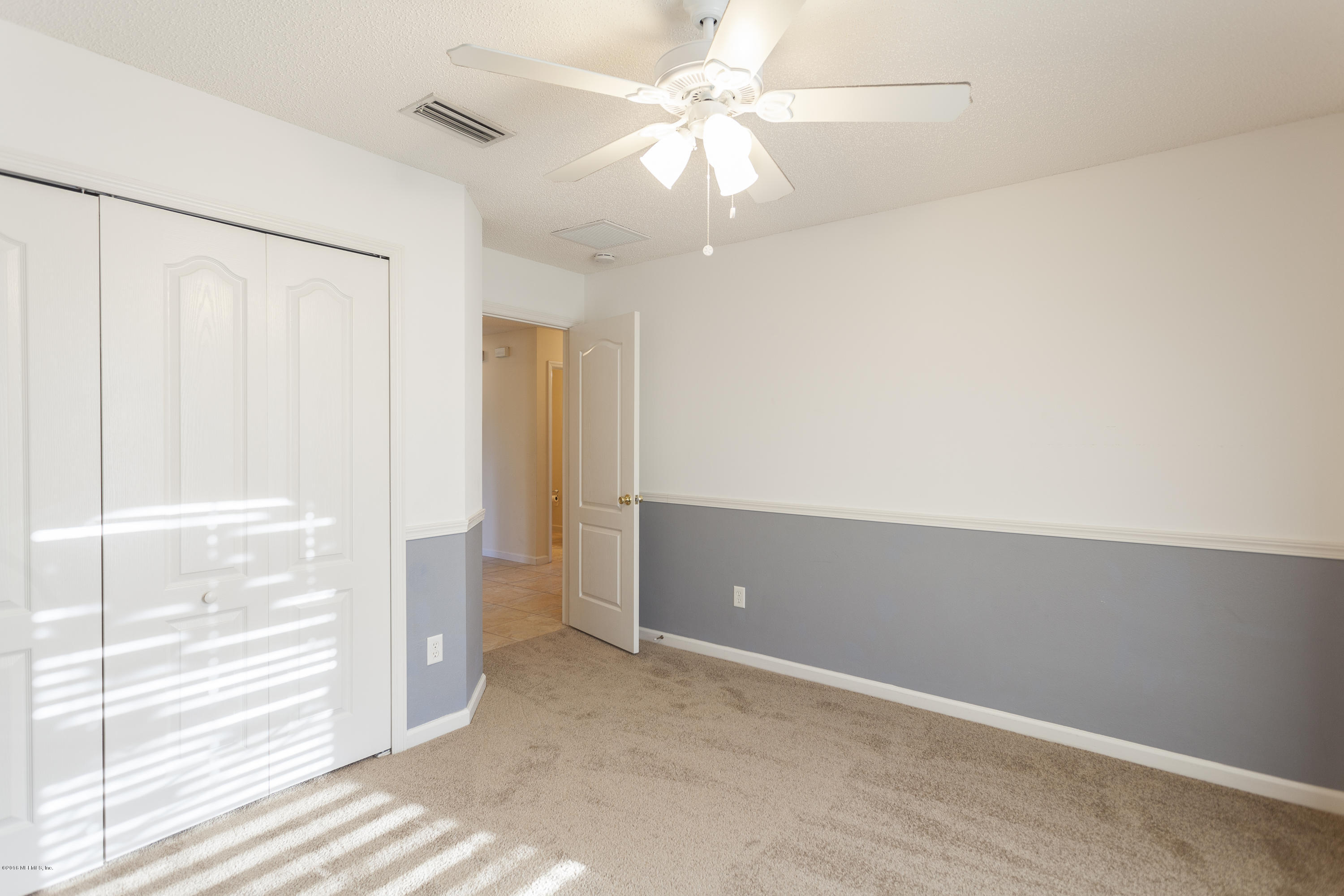 1148 Morning Light Road Jacksonville, FL 32218 - Photo 17 of 28 wooden floor in an empty room with a window