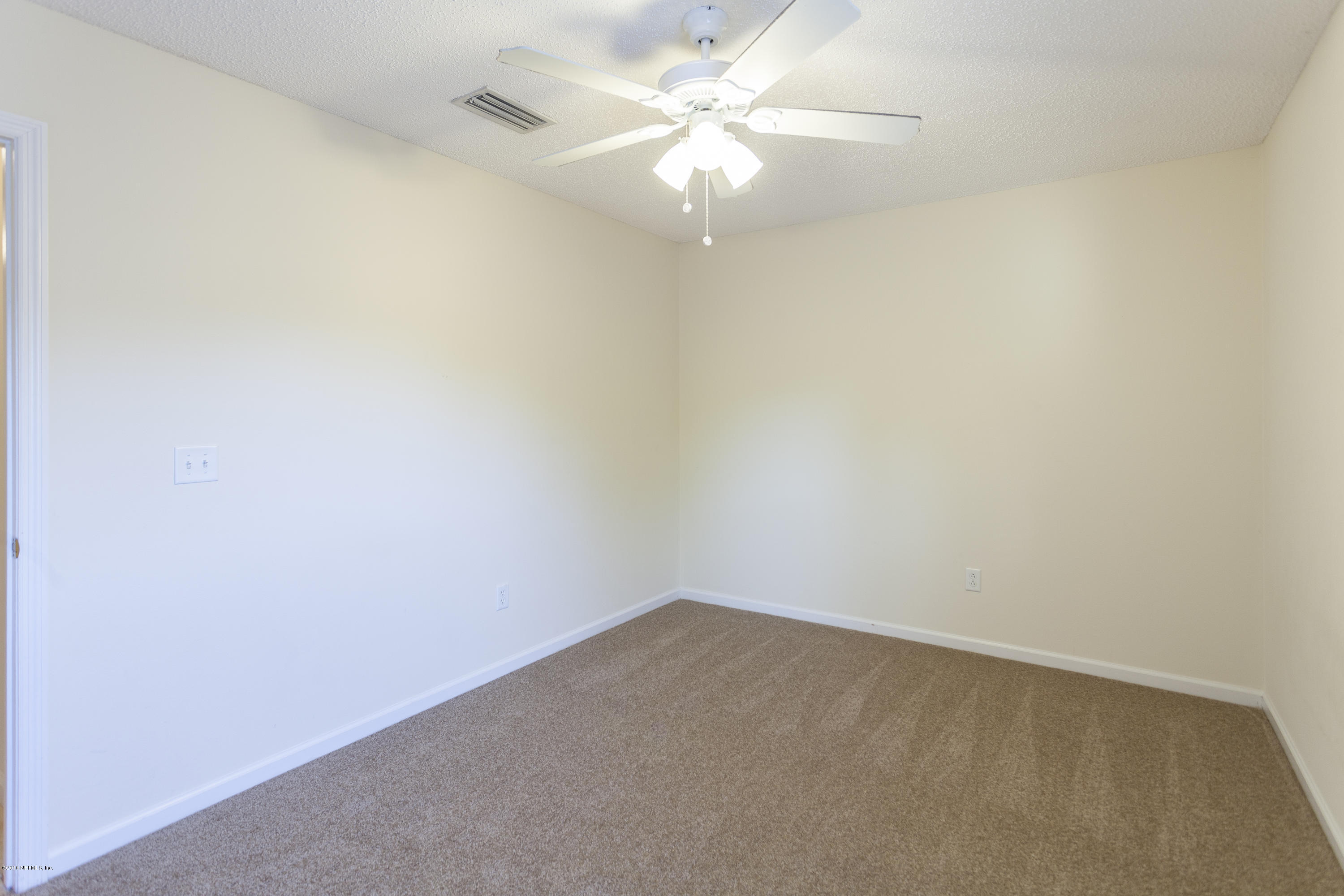 1148 Morning Light Road Jacksonville, FL 32218 - Photo 20 of 28 an empty room with a fan & a window