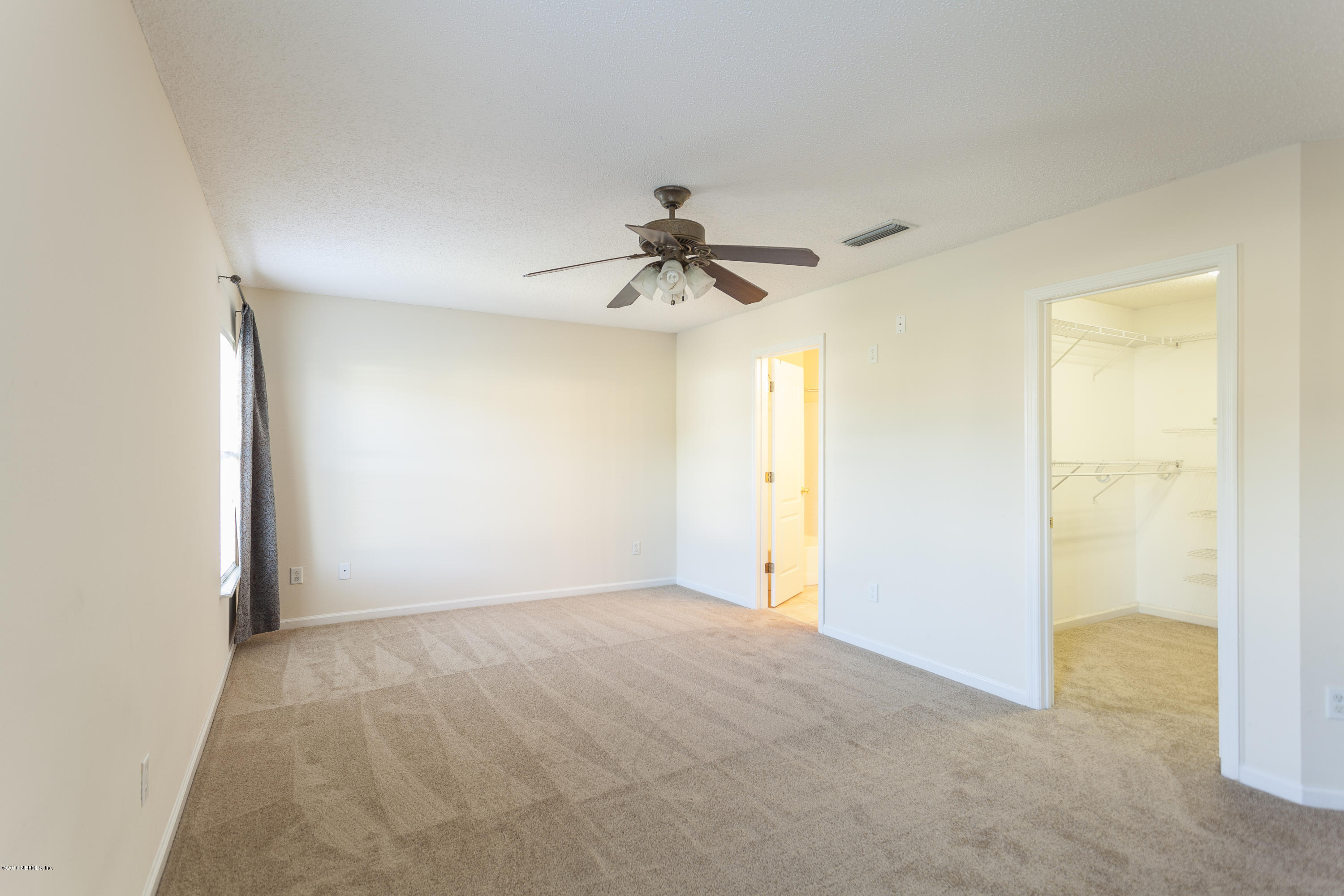 1148 Morning Light Road Jacksonville, FL 32218 - Photo 9 of 28 a view of a room with a ceiling fan and a window