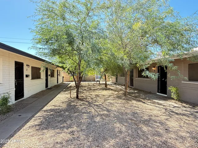 a view of a house with a tree in the background