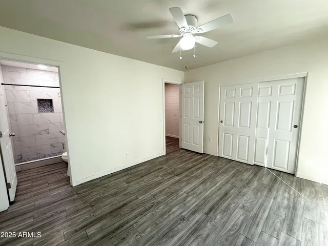 a bathroom with a granite countertop sink a toilet and shower