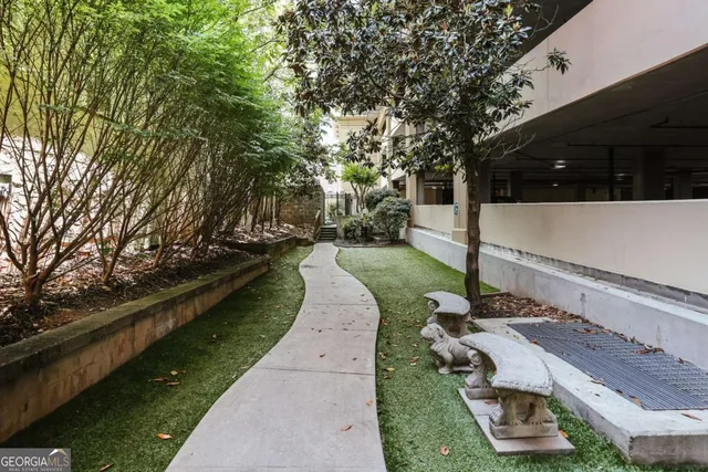 a view of a yard with wooden fence