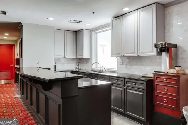 a kitchen with a sink stove and cabinets