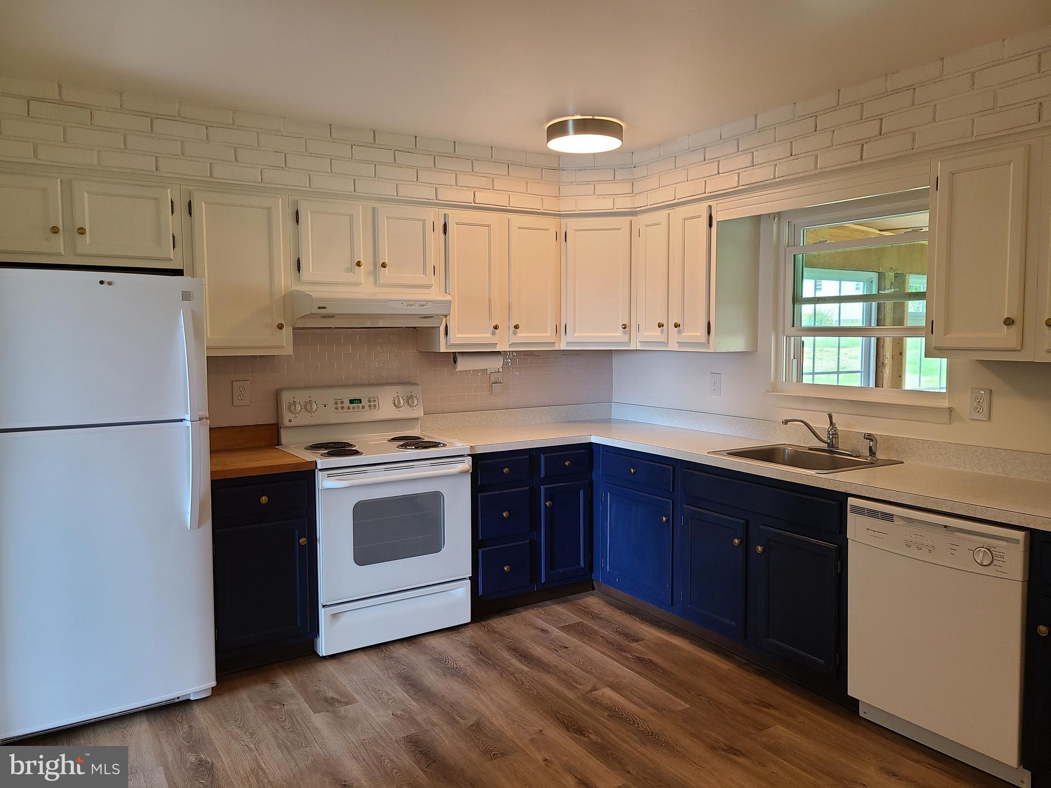 4801 Regal Lane Dunkirk, MD 20754 - Photo 3 of 11 a kitchen with a sink a stove a refrigerator and cabinets
