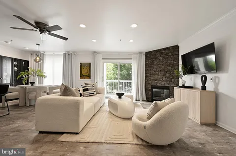 a living room with fireplace furniture and a flat screen tv