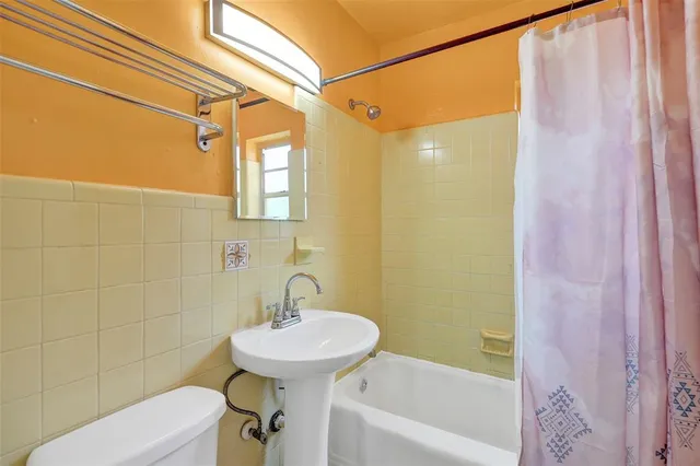 a bedroom with a bed dresser and a window