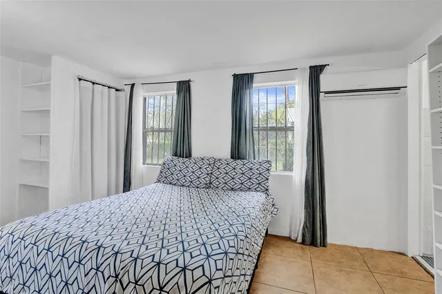 a bedroom with a bed and a view of bathroom