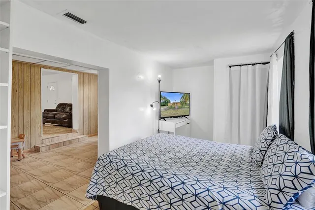 a bedroom with a bed and a dresser