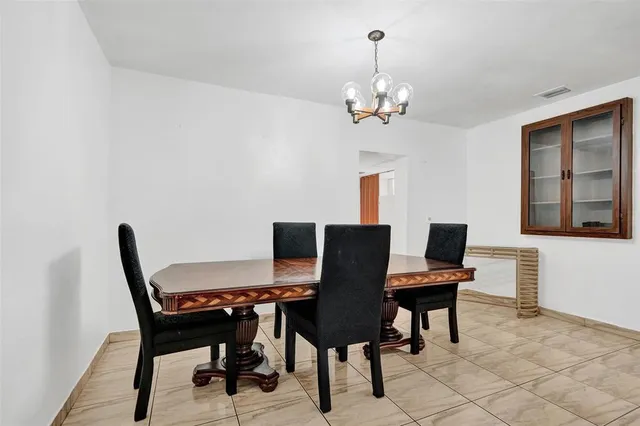 a view of a dining room with furniture and a window