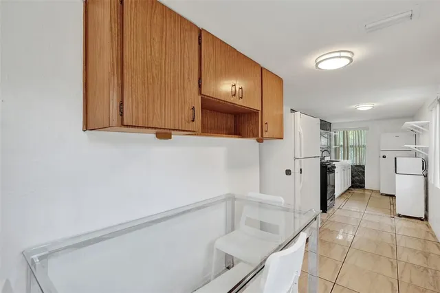 a kitchen with a refrigerator sink and cabinets