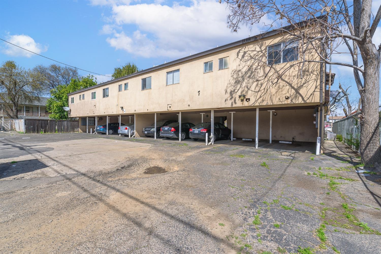 132 West 18th Street Merced, CA 95340 - Photo 13 of 23 a view of a white house with a large space and a yard