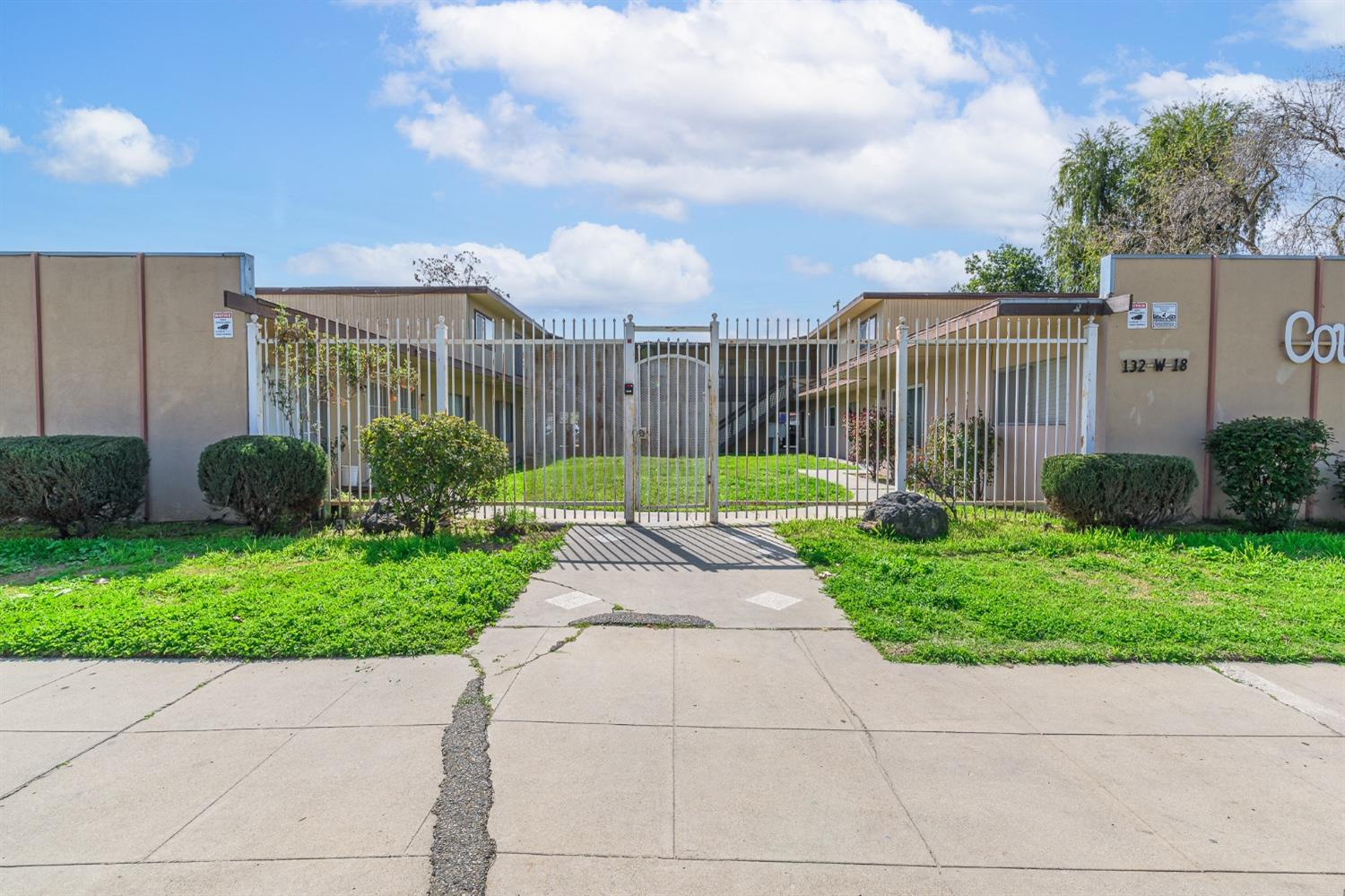 132 West 18th Street Merced, CA 95340 - Photo 2 of 23 a view of a garden with a pathway
