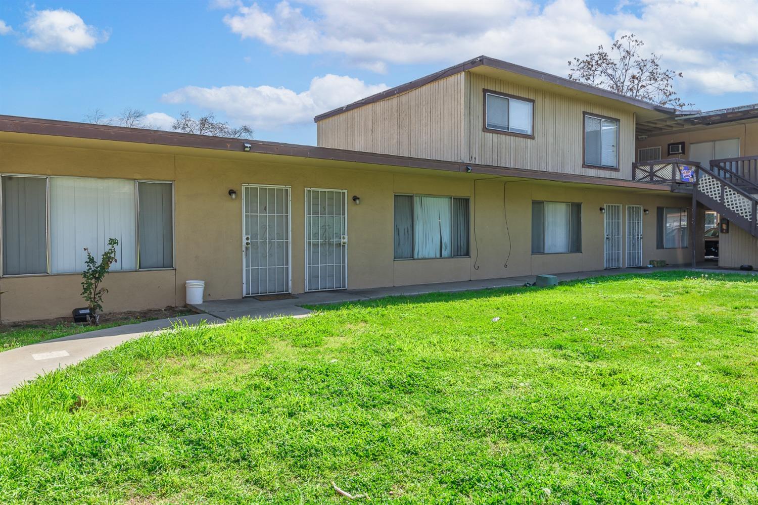 132 West 18th Street Merced, CA 95340 - Photo 5 of 23 a front view of a house with a garden and yard