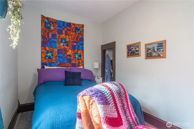 a bedroom with bed and cupboard