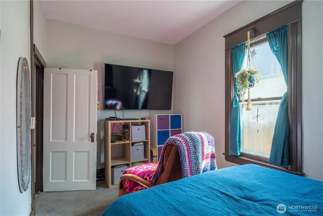 a bedroom with furniture and a window
